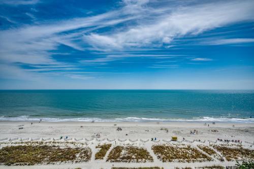 a group of people on a beach with the ocean at Amazing Newly Renovated Atlantica Condo on the 9th flloor in Myrtle Beach