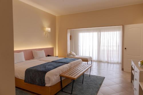 a hotel room with a large bed and a window at La Siesta Hotel Al Sokhna in Ain Sokhna