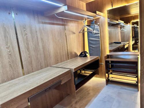 a kitchen with wooden walls and a wooden bench at 2H Hotel in Oran