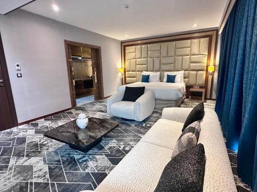 a hotel room with a bed and a couch at 2H Hotel in Oran