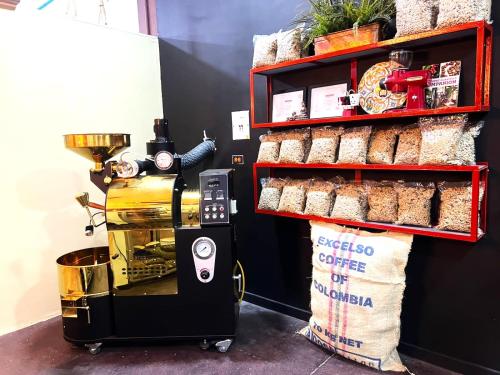 a coffee machine sitting next to a shelf with bread at Hotel Boutique Chateau de la Mar in Juan de Acosta