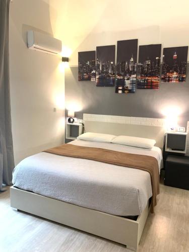 a bedroom with a bed with a city skyline on the wall at Magda House & Parking in Bari