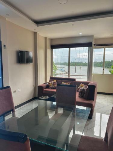 a living room with a glass table and a couch at Puerto Bello in Santa Rosa