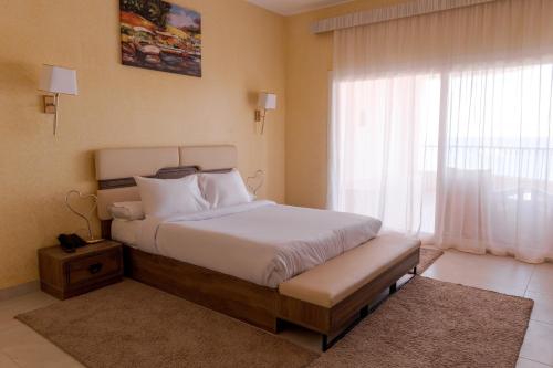 a bedroom with a bed and a large window at La Siesta Hotel Al Sokhna in Ain Sokhna