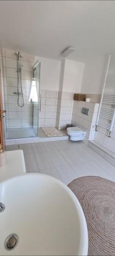 a bathroom with a white sink and a toilet at Stilvolle Ferienwohnung free parking, Space, WLAN in Niestetal