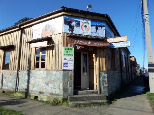 a small building with signs on the side of it at Hostal Epu Pewen in Curacautín