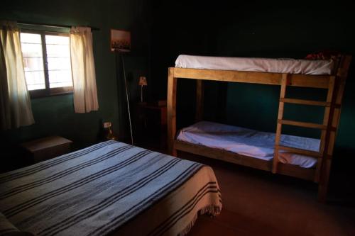 a bedroom with two bunk beds and a window at La Martina in Los Árboles