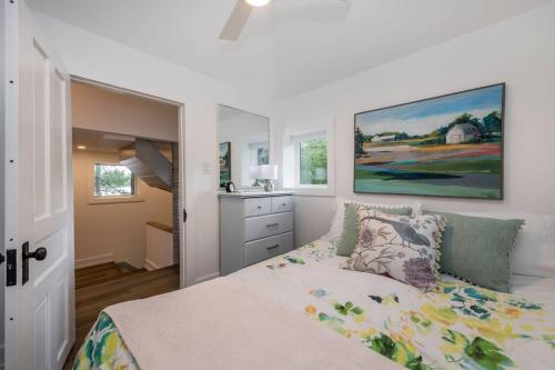 a bedroom with a bed and a painting on the wall at Gorgeous Muskokan Cottage on Six Mile Lake in Port Severn