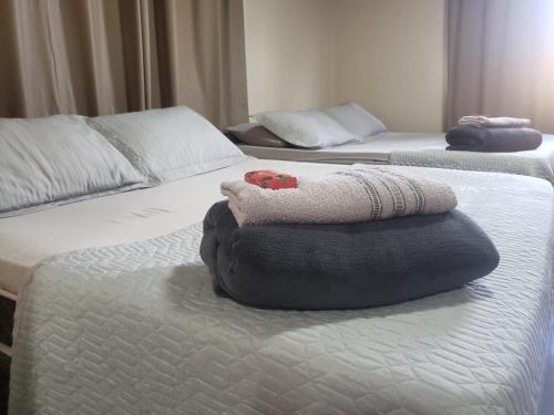 two beds with pillows on top of each other at Hospedagem Costa BNU - PLUS in Blumenau