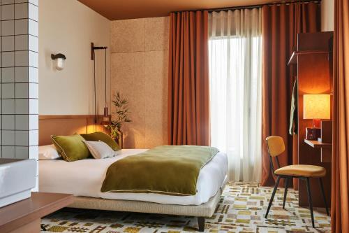 a bedroom with a large bed and a window at Hôtel Oré, Saint-Malo in Saint Malo