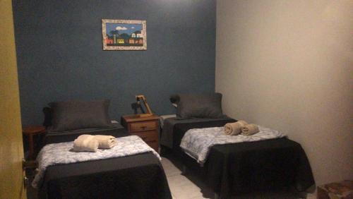 a room with two beds with stuffed animals on them at Sítio por do Sol - Pedra Azul - ES in Pedra Azul