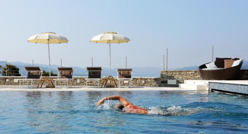 a person in the water in a swimming pool at Relais San Maurizio in Santo Stefano Belbo