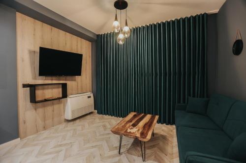 a living room with a couch and a table at B.G Luxury Suites in Korçë