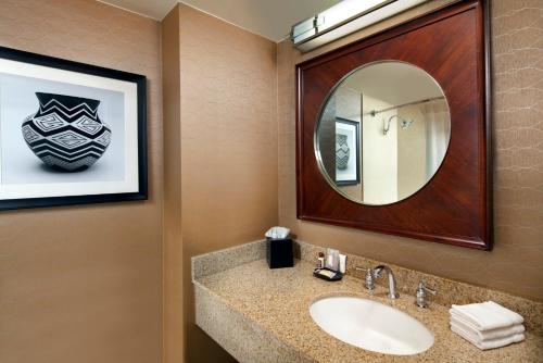 a bathroom with a sink and a mirror at Sheraton Hotel Denver Tech Center in Greenwood Village