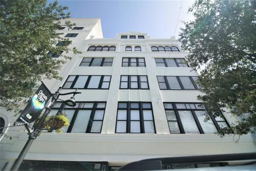 a tall white building with a flag in front of it at The Lofts on Clematis 404 Downtown West Palm Beach in West Palm Beach