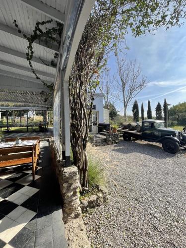 a car parked next to a building with a tree at Narbona Wine Lodge in Carmelo