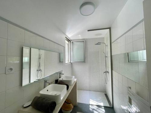 a white bathroom with a sink and a shower at Villa JFK in Marseille