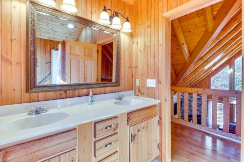a bathroom with a sink and a mirror at Private Hot Tub and Fire Pit Log Cabin in Blakeslee in Blakeslee
