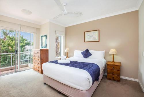 a bedroom with a large bed and a window at Bridgewater Terraces in Brisbane