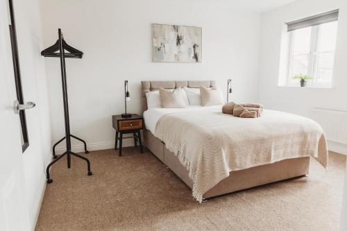 a white bedroom with a large bed in it at Golden Flatts Apartment in Hartlepool