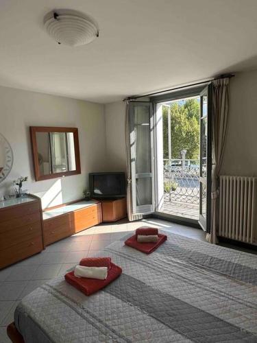 a bedroom with a large bed with red towels on it at Appartamento vista Lago in Lecco