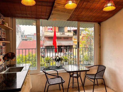 a kitchen with a table and chairs in front of a window at Central Cozy apartment - Beer street 201#301 in Hanoi