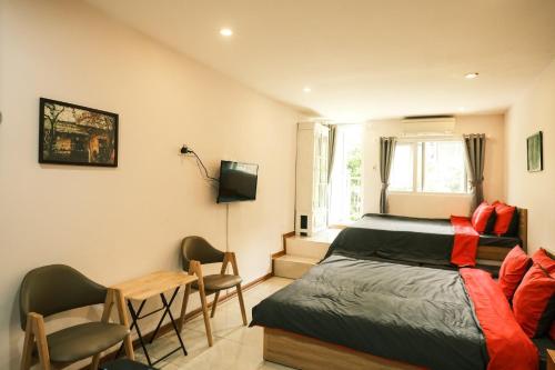 a bedroom with a bed and a desk and a television at Central Cozy apartment - Beer street 201#301 in Hanoi