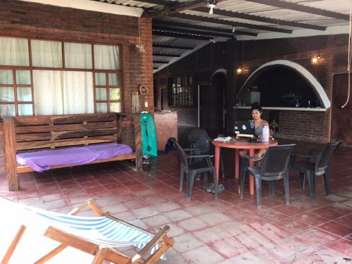 a woman sitting at a table with a laptop at Casa Vieja Surf Spa Mizata in La Libertad