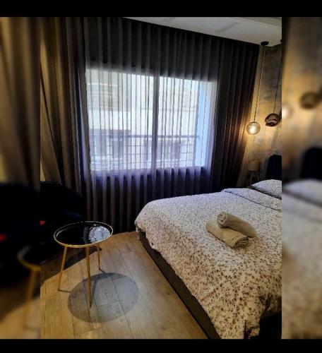 a bedroom with a bed and a window at Urbain palace in Casablanca