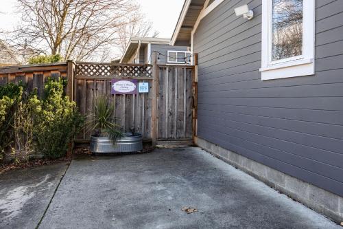 a driveway in front of a house with a fence at Hanna's House by WanderLodges in Ashland