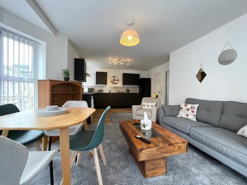 a living room with a couch and a table at Eden Corner - 2 Bed in Morecambe