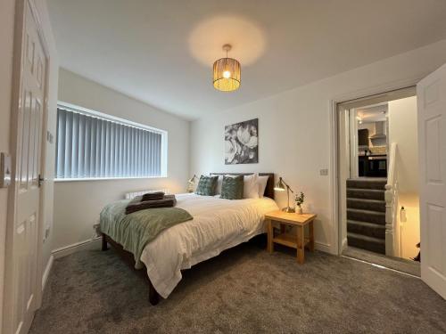 a bedroom with a large bed and a table at Surprise sea view cosy apartment in Morecambe