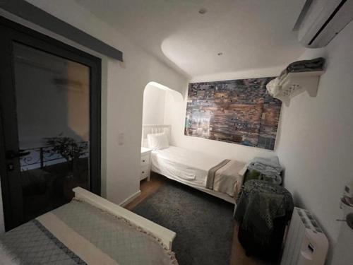 a bedroom with a bed and a brick wall at The Blue House in Olhão