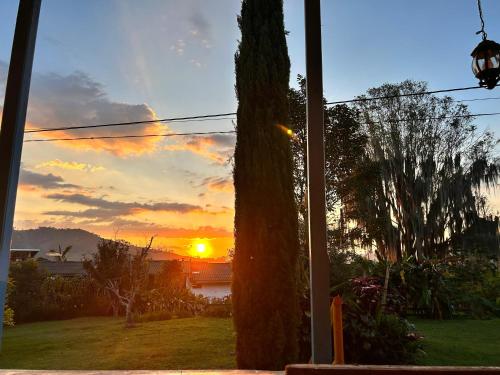 a sunset seen through a window of a house at Buriti EcoH RNT56521, via Termales Santa Rosa de Cabal in Santa Rosa de Cabal