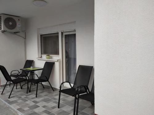 a room with chairs and a table and a window at Apartment GORA in Međugorje