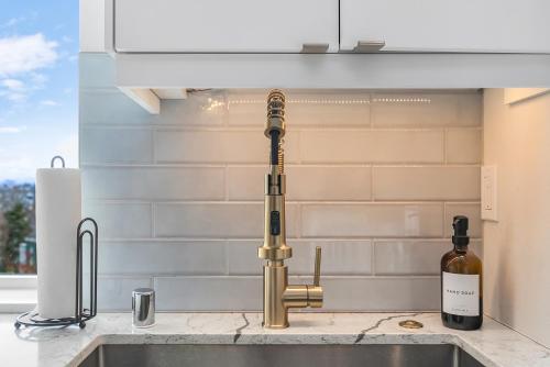 a kitchen sink with a kitchen faucet and a bottle of wine at Back to The Future Sweet Suites in Seattle