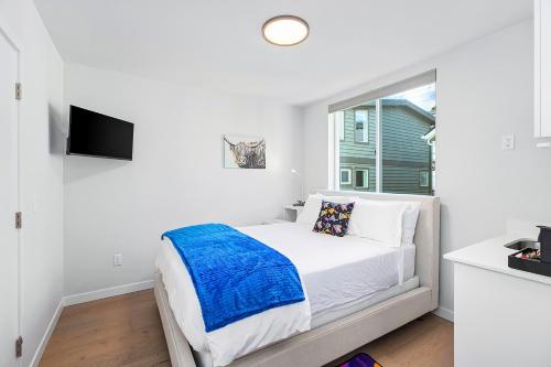 a white bedroom with a bed and a window at Back to The Future Sweet Suites in Seattle