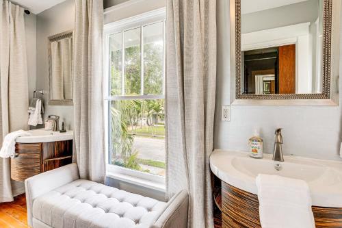 a bathroom with a sink and a window at Lush West Palm Beach Getaway with Backyard Oasis! in West Palm Beach