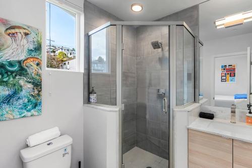 a bathroom with a shower and a toilet and a sink at Back to The Future Sweet Suites in Seattle