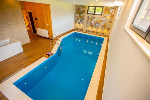 a large swimming pool in a room at Villa Rose in Sarajevo