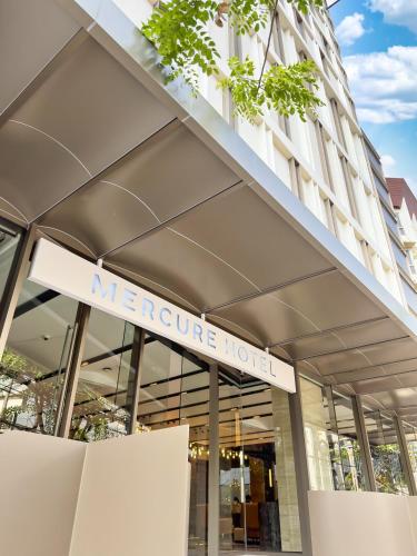 a sign on the front of a store at Mercure Bangkok Surawong in Bangkok