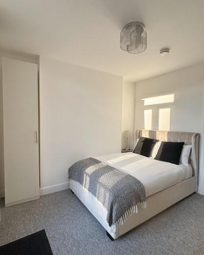 a bedroom with a large bed and a window at Cardiff/Penarth Home in Cardiff