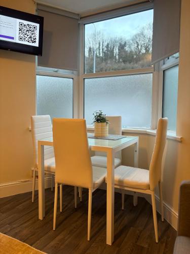 a dining room with a table and chairs and a window at Cardiff/Penarth Home in Cardiff