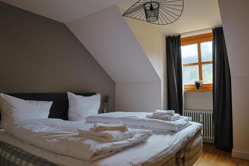 a bedroom with two beds with towels on them at Edelschwarz Allgäu in Oberstaufen