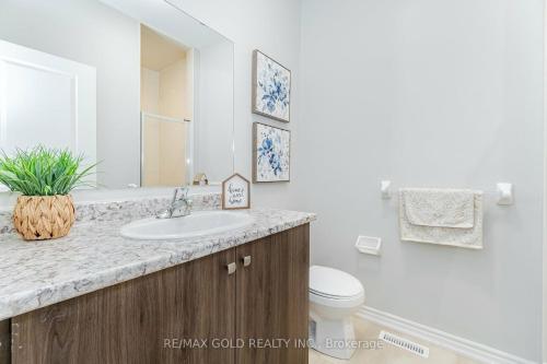 a bathroom with a sink and a toilet at Modern 3 bedroom home in Brampton in Brampton