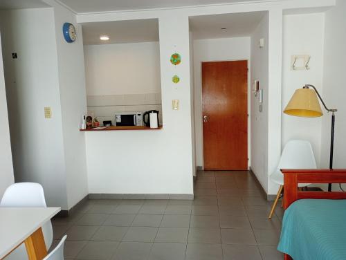 a hallway with a room with a bed and a door at Hogareño departamento calle 42 in La Plata