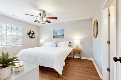 a bedroom with a bed and a ceiling fan at Palmetto Paradise, SC in Pawleys Island