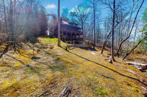 a train sitting in the middle of a forest at Lazy Bear Creek Lodge in Blairsville