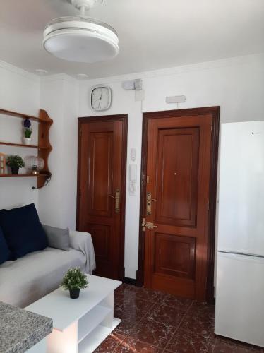 a living room with a couch and a door at Aires de Grazalema in Prado del Rey