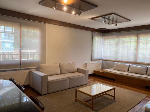 uma sala de estar com um sofá e uma mesa em Apartamento em canela em Canela